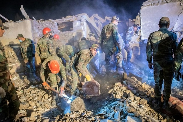 rescue teams sift through rubble of a missile azerbaijan s ganja which marks a dramatic broadening of the nagorno karabakh conflict photo afp