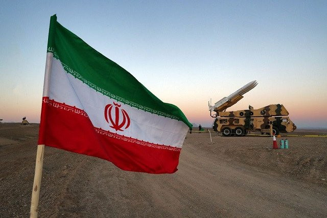 an iranian flag is pictured near in a missile during a military drill with the participation of iran s air defense units iran october 19 2020 picture taken october 19 2020 photo reuters