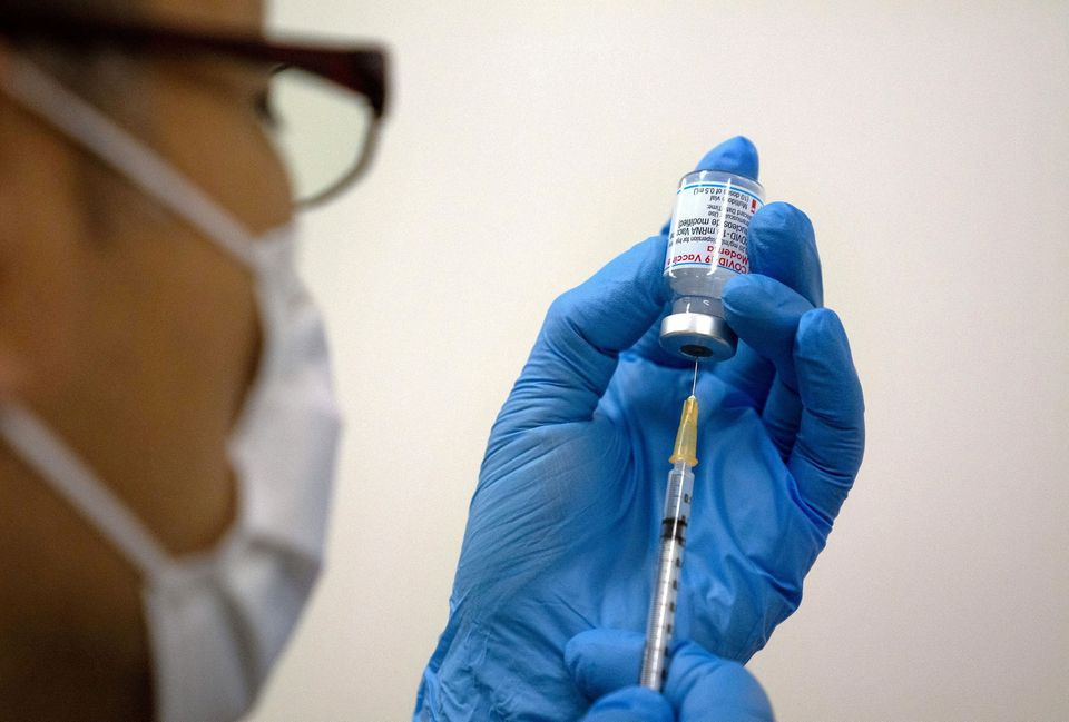 medical staff prepare moderna coronavirus covid 19 vaccine to be administered at newly opened mass vaccination centre in tokyo japan may 24 2021 photo reuters file