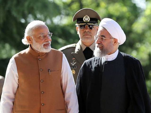 iranian president hassan rouhani right walks alongside indian prime minister narendra modi during a welcome ceremony in tehran on may 23 2016 photo afp