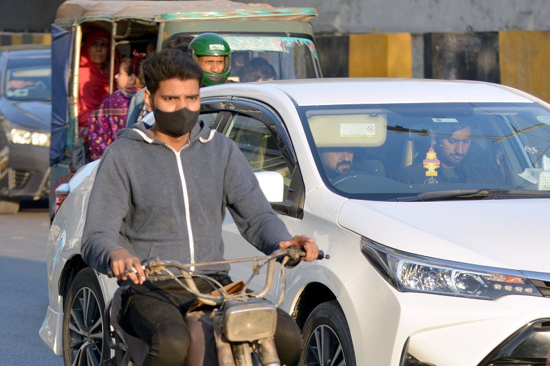 A majority of motorcyclist in Karachi drive around their motorcycles without rear view mirrors. PHOTO: EXPRESS