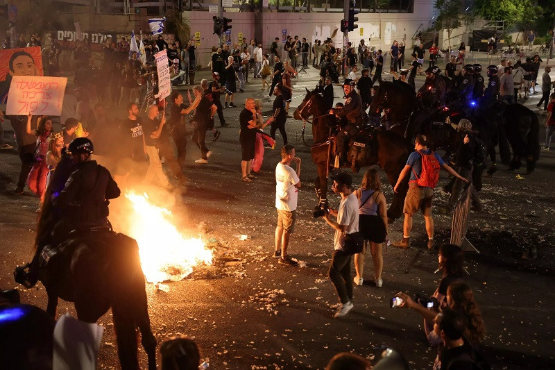 Mounted Israeli police try to disperse a demonstration by relatives and supporters of Israelis held hostage by Palestinian Hamas fighters in Gaza since the October 7 attacks, in Tel Aviv early on June 2, 2024. PHOTO: AFP