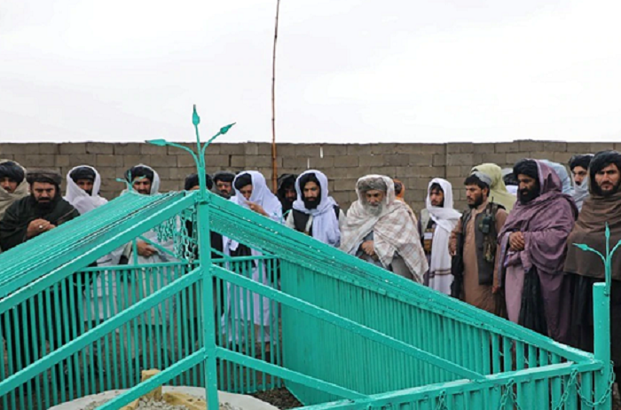 members of the taliban stand next to the tomb of late afghan taliban leader mullah omar at omarzo in suri district of zabul province photo afp