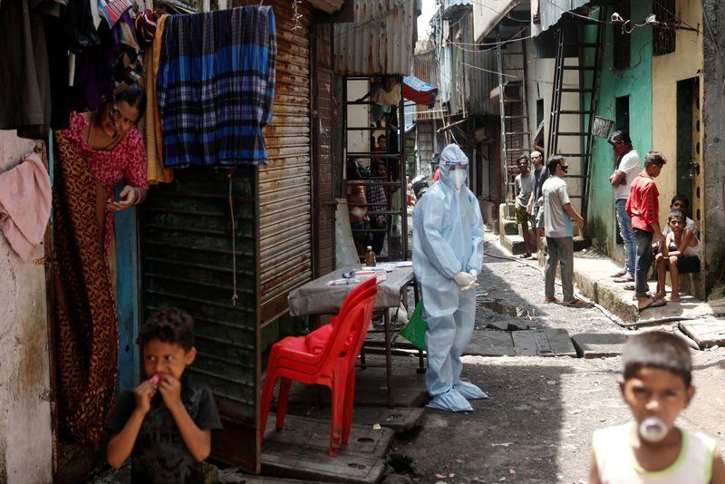 a healthcare worker wearing personal protective equipment ppe waits to test residents during a medical campaign for the coronavirus disease covid 19 at a slum area in mumbai india june 30 2020 photo reuters