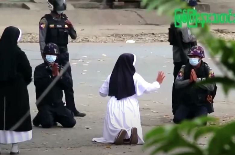 a myanmar nun sister ann rose nu tawng kneeled before police officers in the city of myitkyina to ask security forces to refrain from violence against children and residents screengrab reuters