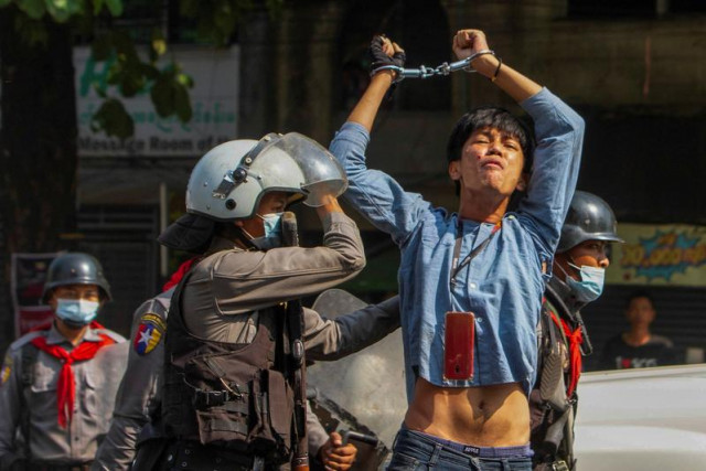 a pro democracy protester is detained by riot police officers during a rally against the military coup in yangon myanmar february 27 2021 photo reuters a pro democracy protester is detained by riot police officers during a rally against the military coup in yangon myanmar february 27 2021 photo reuters