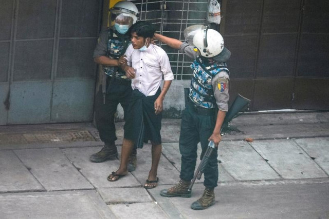 riot police officers detain a demonstrator during a protest against the military coup in yangon myanmar march 19 2021 photo reuters riot police officers detain a demonstrator during a protest against the military coup in yangon myanmar march 19 2021 photo reuters