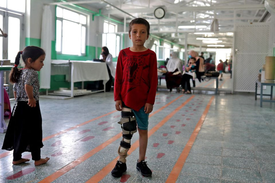 Idris, 8, who lost his leg in a mine in Ghorband, poses for a photograph at the Red Cross rehabilitation center in Kabul, Afghanistan, April 9, 2022. REUTERS