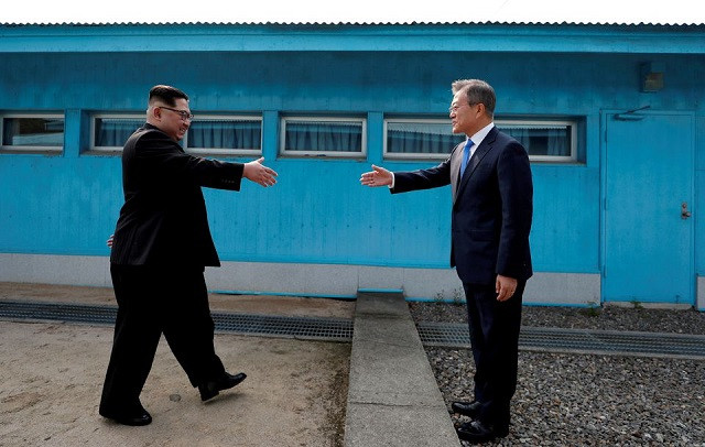 south korean president moon jae in and north korean leader kim jong un shake hands at the truce village of panmunjom inside the demilitarized zone separating the two koreas photo reuters