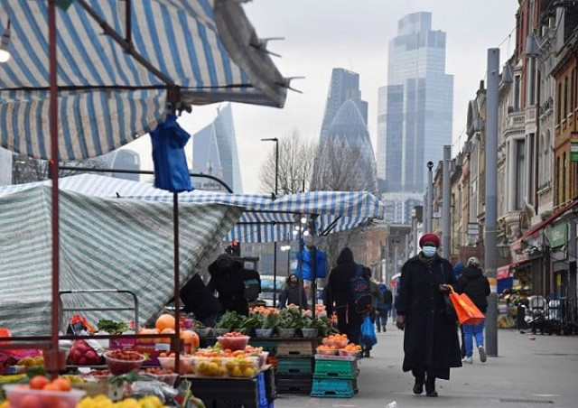 people shop at market stalls with skyscrapers of the city of london financial district seen behind amid the covid 19 pandemic in london britain photo reuters people shop at market stalls with skyscrapers of the city of london financial district seen behind amid the covid 19 pandemic in london britain photo reuters