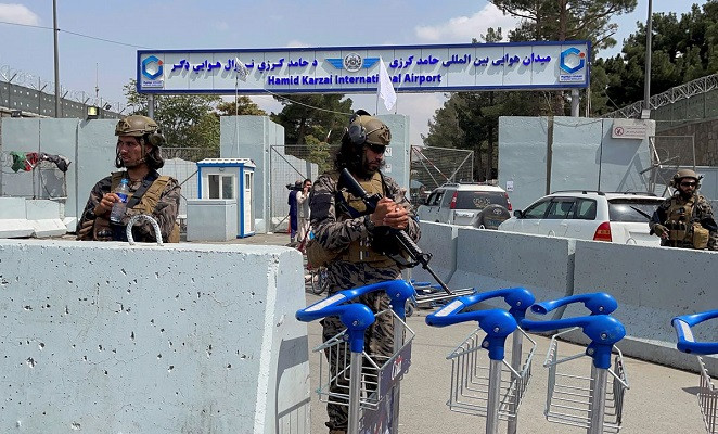 taliban forces stand guard at the entrance gate of hamid karzai international airport a day after u s troops withdrawal in kabul afghanistan august 31 2021 photo reuters