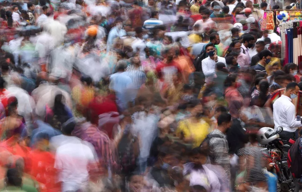 a man speaks on the phone as people walk past him at a crowded market amidst the spread of the coronavirus disease covid 19 in mumbai india september 5 2021 photo reuters a man speaks on the phone as people walk past him at a crowded market amidst the spread of the coronavirus disease covid 19 in mumbai india september 5 2021 photo reuters