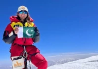 pakistani mountaineer naila kiani holding up a pakistani flag to celebrate after scaling the peak of nanga parbat which is known as killer mountain and second highest peak after k2 in pakistan photo courtesy naila kiani