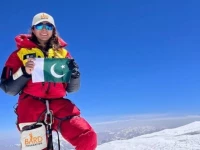 pakistani mountaineer naila kiani holding up a pakistani flag to celebrate after scaling the peak of nanga parbat which is known as killer mountain and second highest peak after k2 in pakistan photo courtesy naila kiani