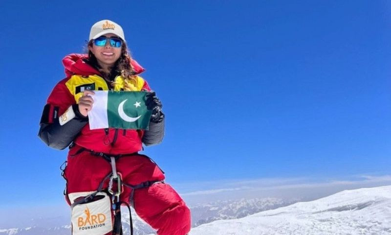 pakistani mountaineer naila kiani holding up a pakistani flag to celebrate after scaling the peak of nanga parbat which is known as killer mountain and second highest peak after k2 in pakistan photo courtesy naila kiani