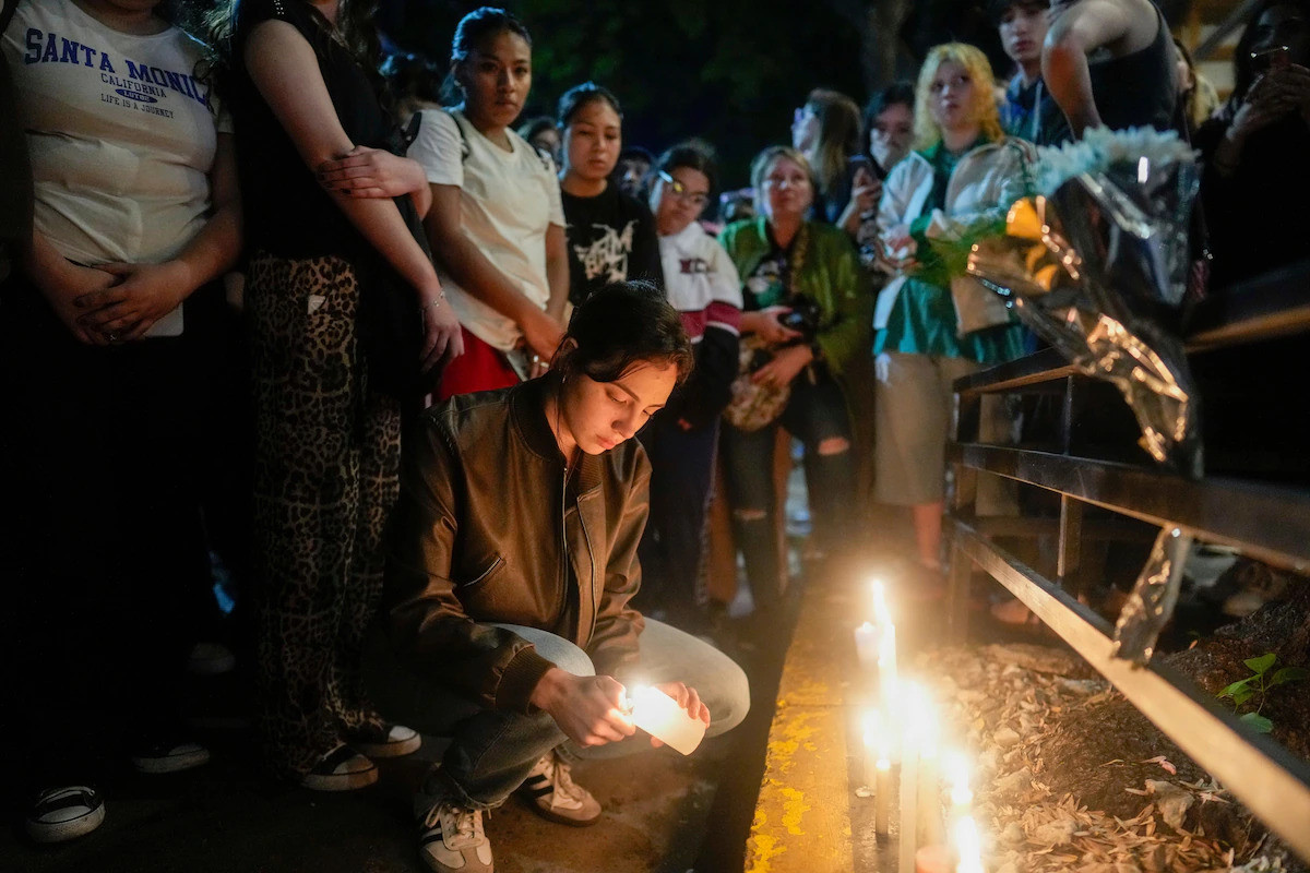 Fans light candles outside the hotel where former One Direction singer Liam Payne was found dead after falling from the third floor of a hotel in Buenos Aires on Wednesday. (Natacha Pisarenko/AP)