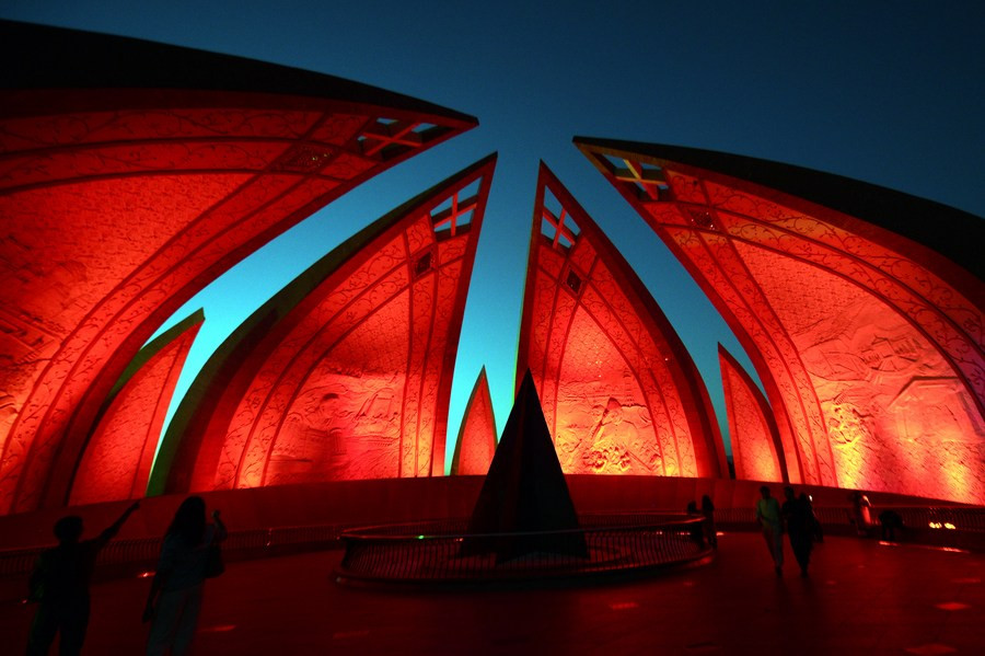 People visit the National Monument illuminated in red to celebrate the 74th anniversary of the founding of the People's Republic of China, in Islamabad on Oct. 1, 2023. PHOTO: XINHUA