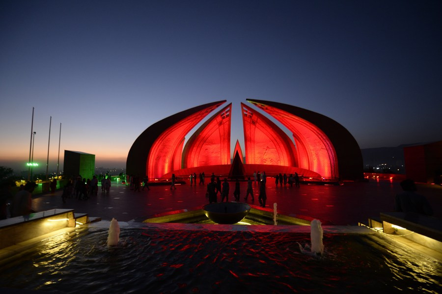 People visit the National Monument illuminated in red to celebrate the 74th anniversary of the founding of the People's Republic of China, in Islamabad on Oct. 1, 2023. PHOTO: XINHUA