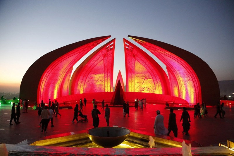 people visit the national monument illuminated in red to celebrate the 74th anniversary of the founding of the people s republic of china in islamabad on oct 1 2023 photo xinhua