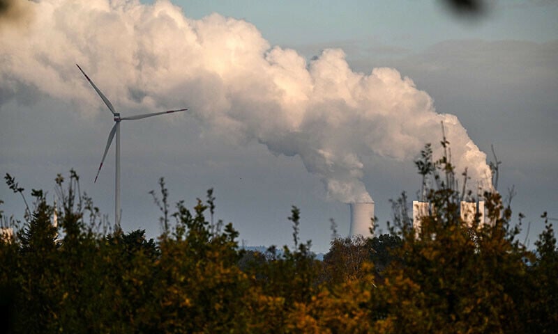 this picture taken on november 12 shows a wind turbine at the lignite fired power station operated by german energy giant rwe near neurath western germany afp