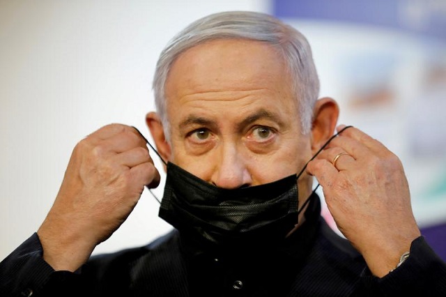 israeli prime minister benjamin netanyahu adjusts his protective face mask after receiving a coronavirus disease covid 19 vaccine at sheba medical center in ramat gan israel december 19 2020 photo reuters