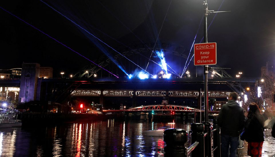 People watch a laser show designed by artist Seb Lee-Delisle and organised by Newcastle City Council to celebrate the New Year in Newcastle upon Tyne, Britain, December 30, 2021. PHOTO: REUTERS