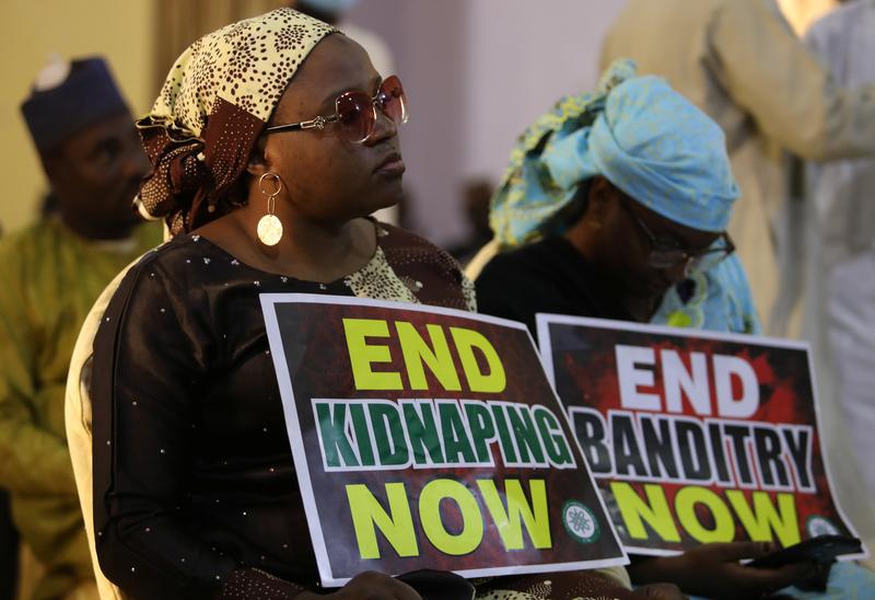 a demonstrator holds a sign during a protest to urge authorities to rescue hundreds of abducted schoolboys in northwestern state of katsina nigeria december 17 2020 photo reuters