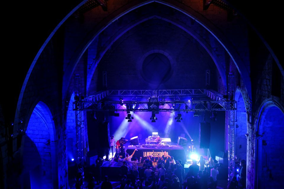 revellers wearing protective face masks dance inside la merce cultural center during open girona initiative which aims to provide a pilot digital health pass scheme to reopen restaurants and businesses amid the coronavirus disease covid 19 pandemic in girona spain may 1 2021 photo reuters