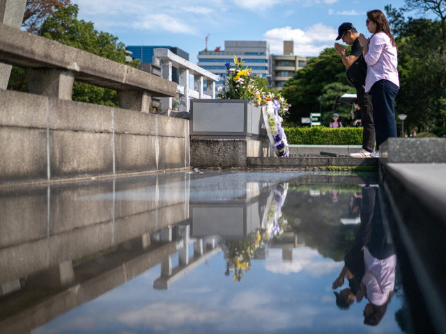visitors pray at the hiroshima peace memorial park in hiroshima city on saturday photo afp visitors pray at the hiroshima peace memorial park in hiroshima city on saturday photo afp