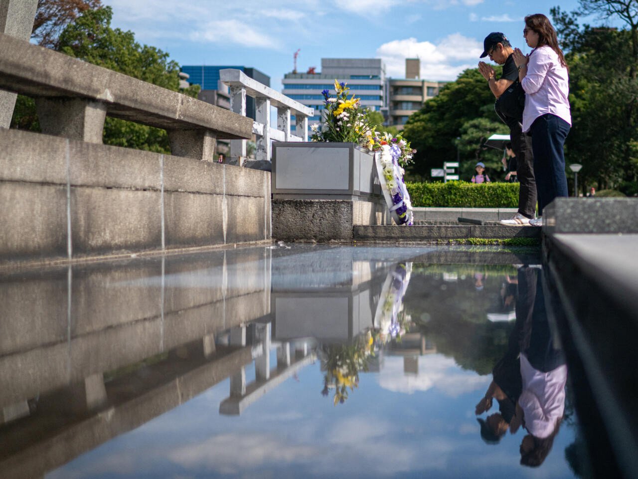 visitors pray at the hiroshima peace memorial park in hiroshima city on saturday photo afp