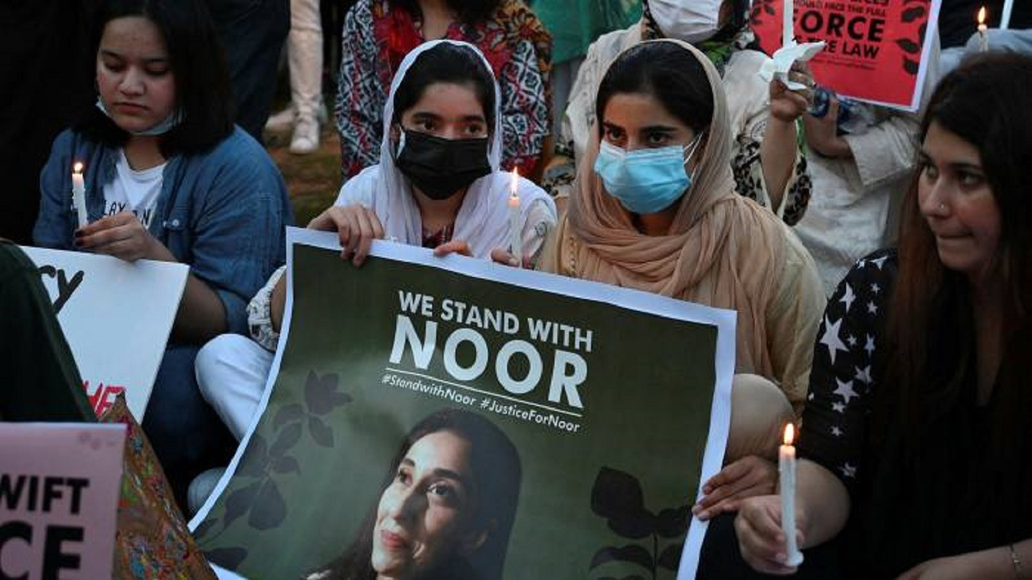 activists hold placards and candles during a protest rally against the brutal killing of noor mukadam the daughter of a former pakistani diplomat who was found murdered at a house in islamabad in july photo afp