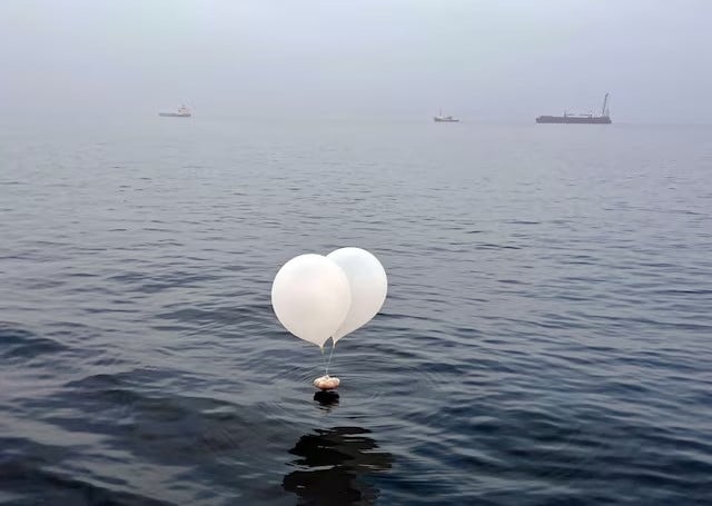 a balloon carrying various objects including what appeared to be trash believed to have been sent by north korea is pictured at the sea off incheon south korea june 9 2024 photo reuters