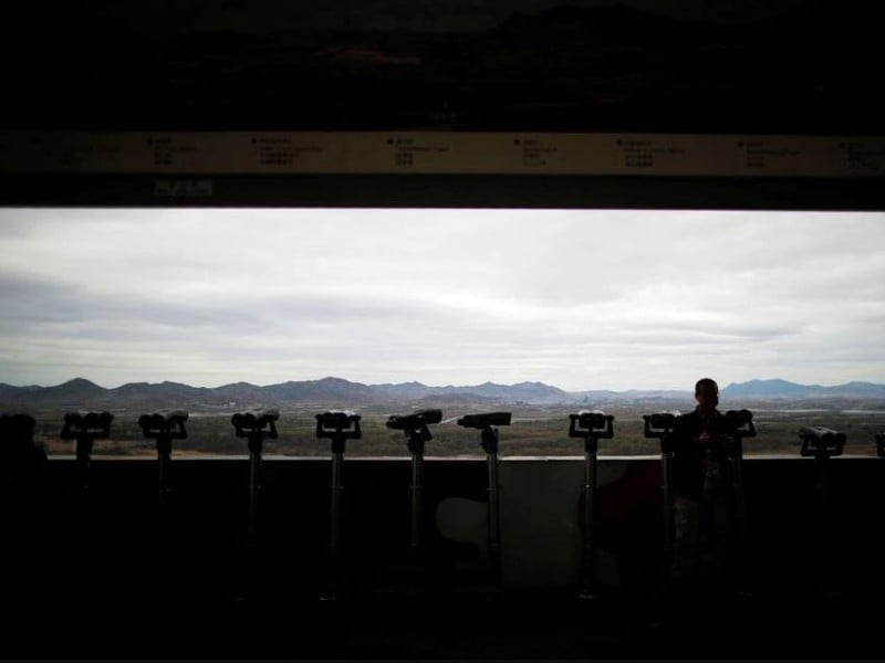 a man stands near binoculars as he tries to see north korea s propaganda village of gijungdong at the dora observatory near the demilitarised zone separating the two koreas in paju south korea april 24 2018 photo reuters file