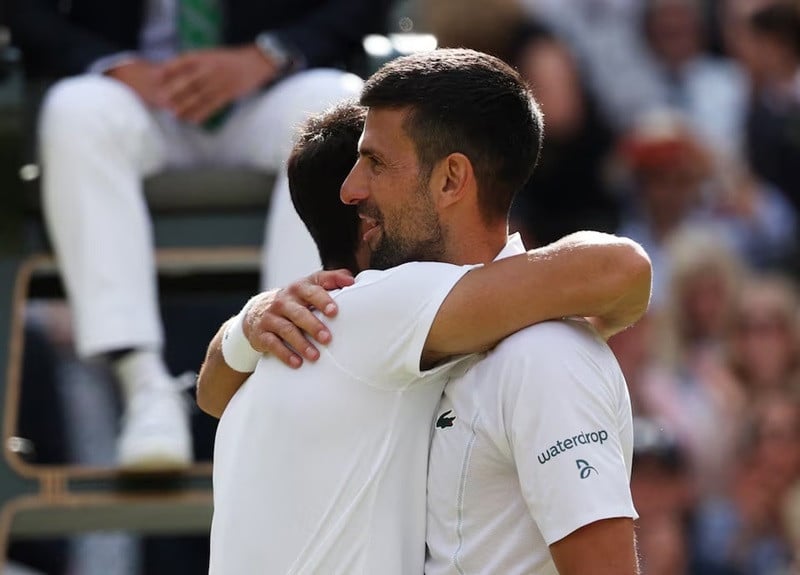 Spain's Carlos Alcaraz consoles Serbia's Novak Djokovic after winning the men's singles final. PHOTO: REUTERS