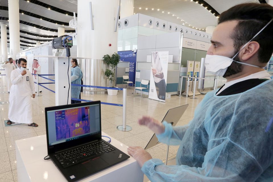 a security man looks at a screen showing the body temperature of travellers at riyadh international airport after saudi arabia reopened domestic flights following the outbreak of the coronavirus disease covid 19 in riyadh saudi arabia may 31 2020 photo reuters file