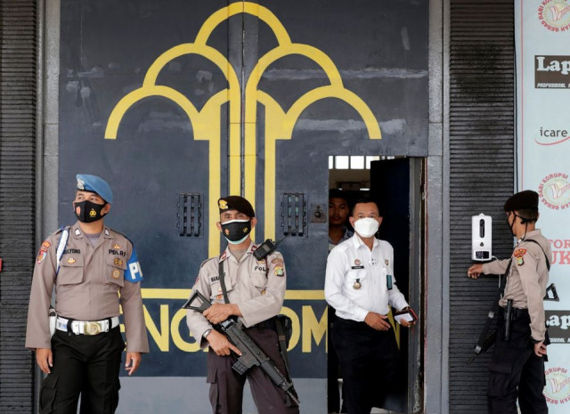 police officer guards at the main entrance gate of tangerang prison following a fire overnight at an overcrowded jail in tangerang on the outskirts of jakarta indonesia september 8 2021 reuters police officer guards at the main entrance gate of tangerang prison following a fire overnight at an overcrowded jail in tangerang on the outskirts of jakarta indonesia september 8 2021 reuters