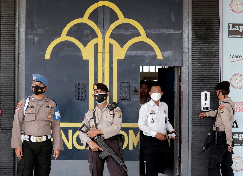 police officer guards at the main entrance gate of tangerang prison following a fire overnight at an overcrowded jail in tangerang on the outskirts of jakarta indonesia september 8 2021 reuters