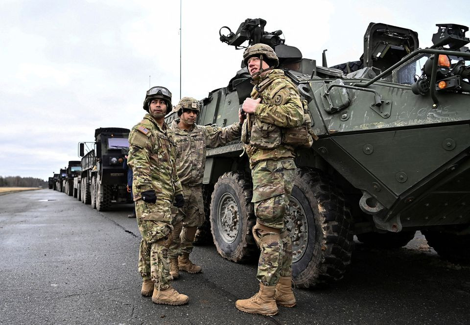 soldiers of the u s 2nd cavalry regiment stand next to a combat vehicle as they prepare their gear for deployment to romania at rose barracks in vilseck germany february 9 2022 photo reuters