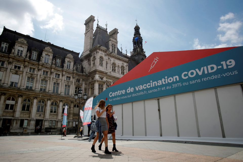 women walk past a coronavirus disease covid 19 vaccination center installated in front of paris town hall france july 7 2021 photo reuters