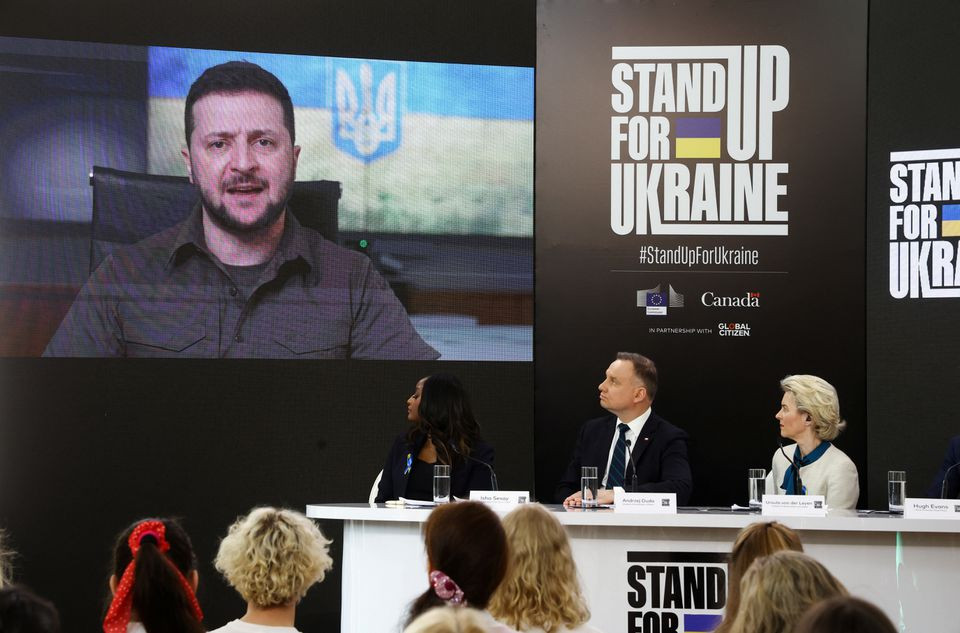 ukrainian president volodymyr zelenskiy is seen on a screen as he participates remotely in a global event titled stand up for ukraine along with european commission president ursula von der leyen and polish president andrzej duda at the palace on the isle in royal lazienki park in warsaw poland april 9 2022 photo reuters