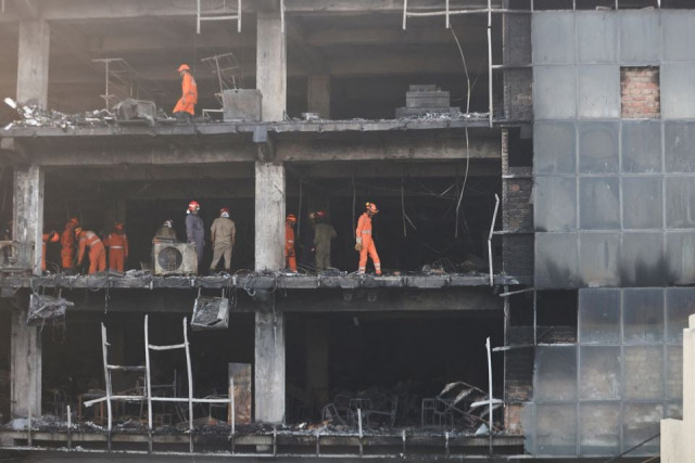 national disaster response force ndrf and fire brigade personnel conduct a search and rescue operation after a fire broke out in a commercial building in new delhi india may 14 2022 reuters