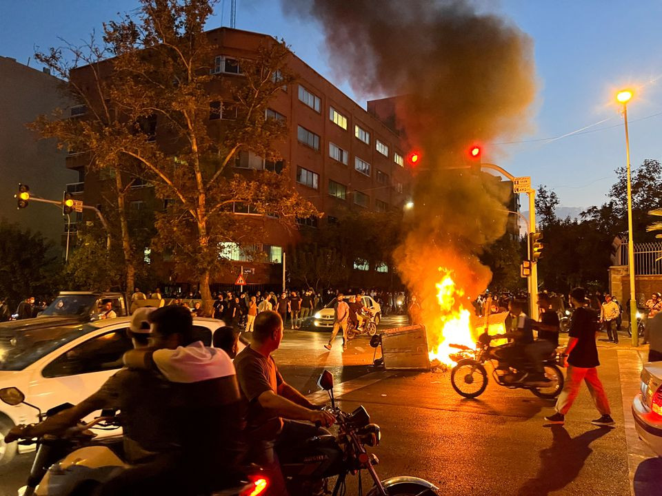 a police motorcycle burns during a protest over the death of mahsa amini a woman who died after being arrested by the islamic republic s morality police in tehran iran september 19 2022 wana west asia news agency via reuters