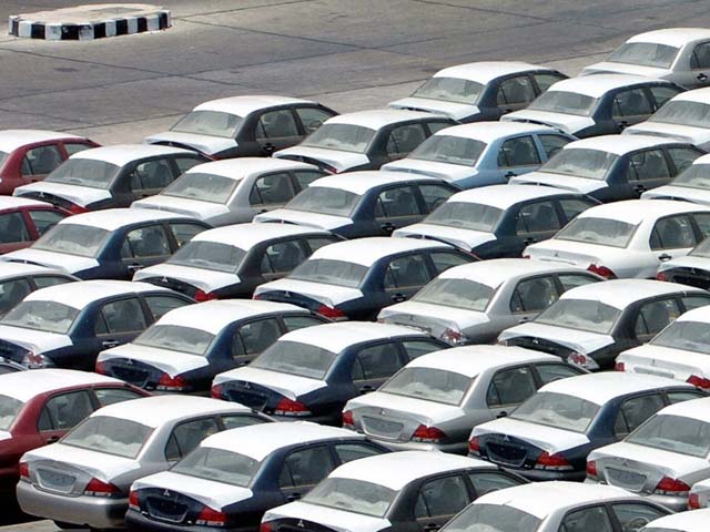 rows of new cars parked on the dockside at karachi photo afp
