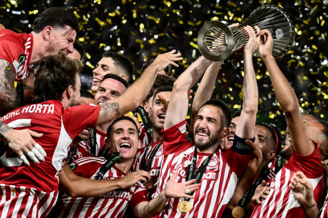 champions olympiakos konstantinos fortounis c holding the europa conference league trophy photo afp