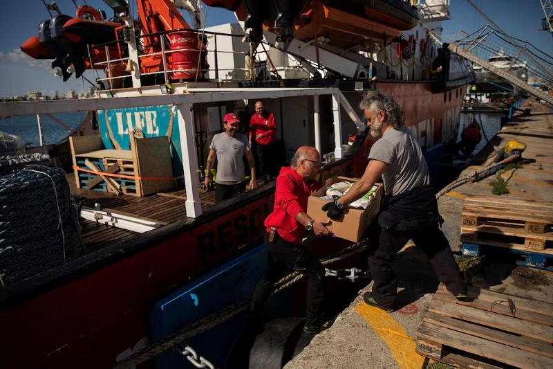 Open Arms members carry humanitarian aid for Gaza in a joint mission between NGOs Open Arms and World Central Kitchen at a port of Larnaca, Cyprus, March 9, 2024. PHOTO: REUTERS