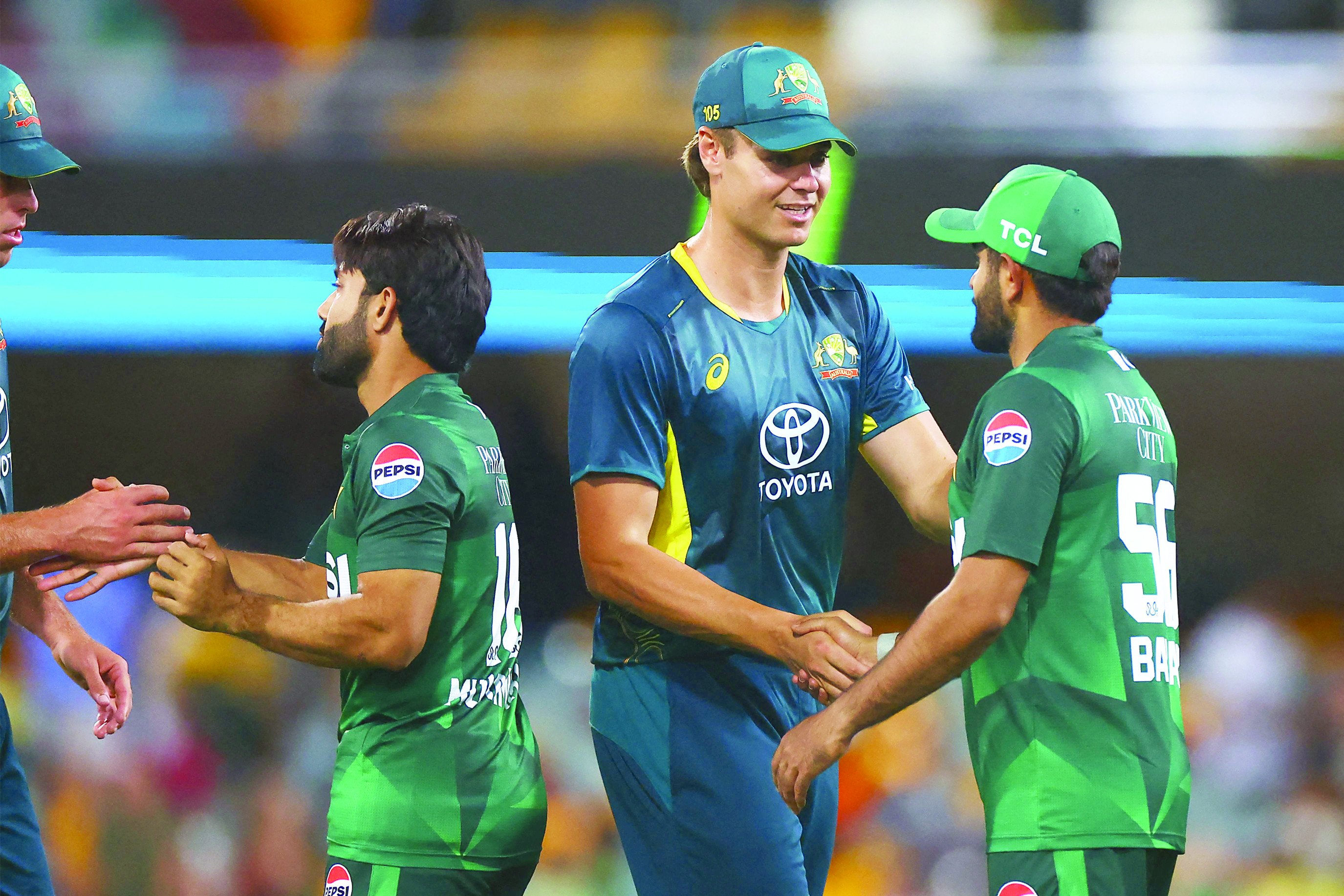 pakistan captain mohammad rizwan and batter babar azam shake hands with the aussies after the rain hit first twenty20 at brisbane on thursday photo afp