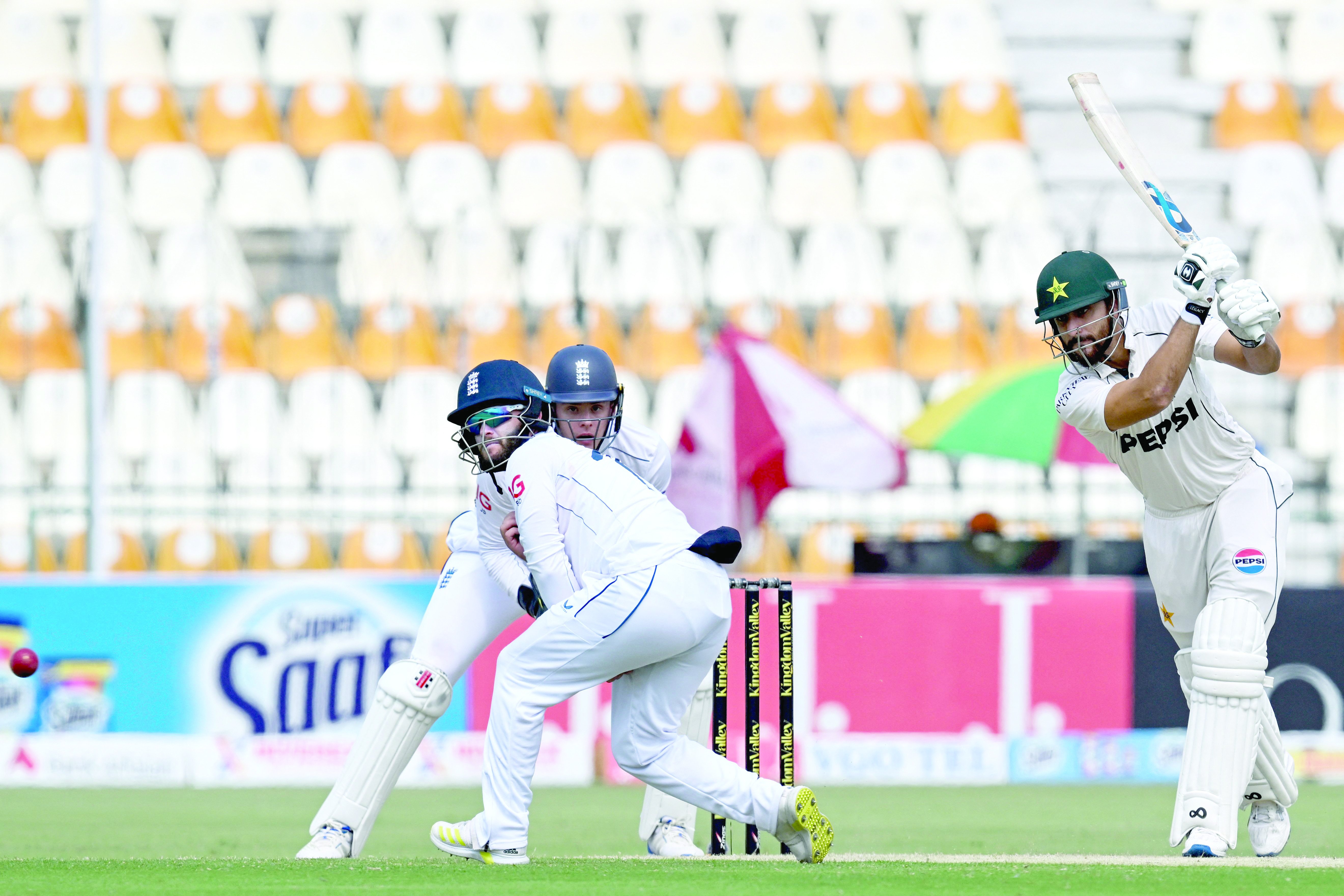 pakistan s agha salman r plays a shot as england wicketkeeper jamie smith watches on the second day of the first test at multan photo afp