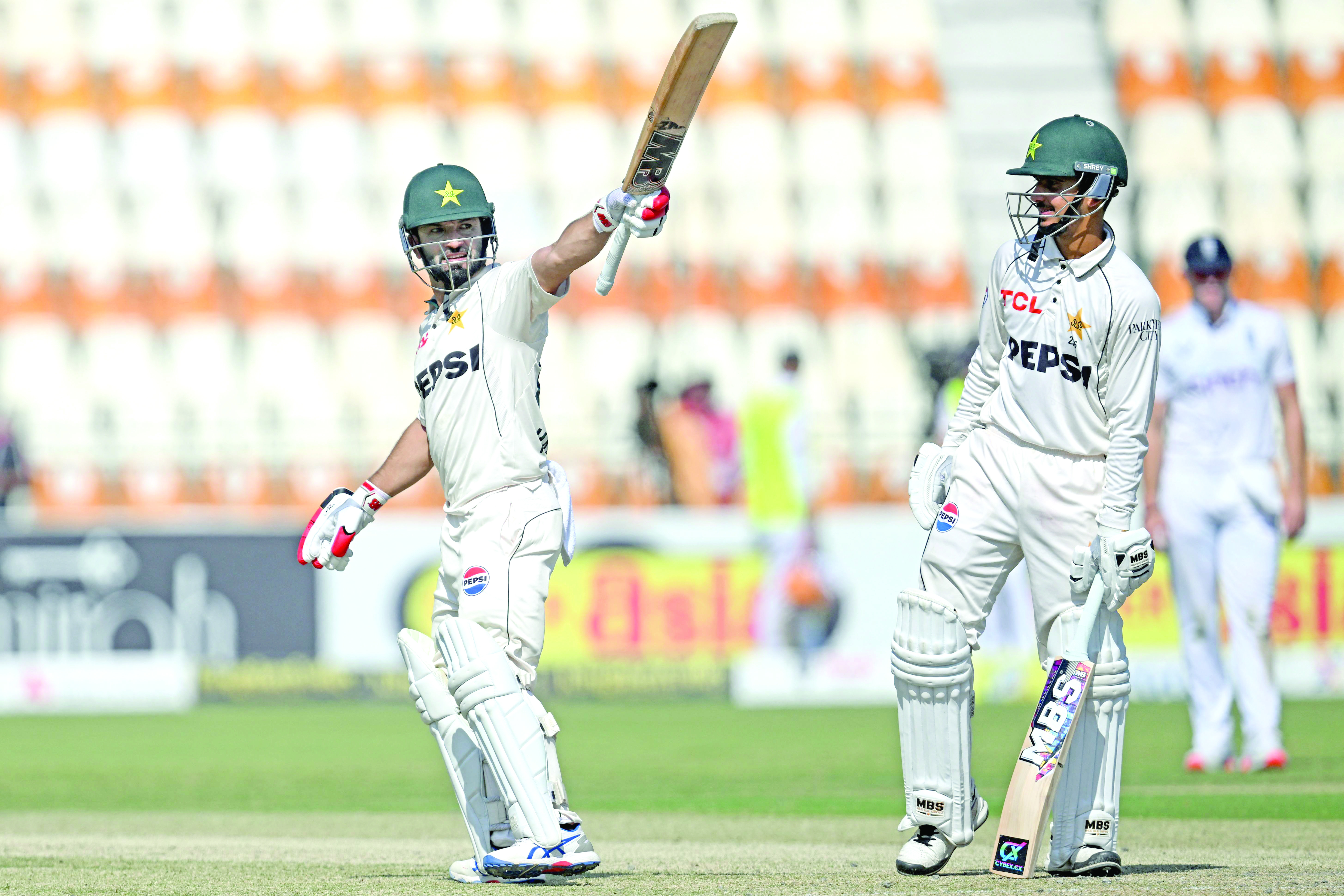 pakistan s kamran ghulam l celebrates after scoring a half century against england as saim ayub looks on during the first day of the second test at multan photo afp