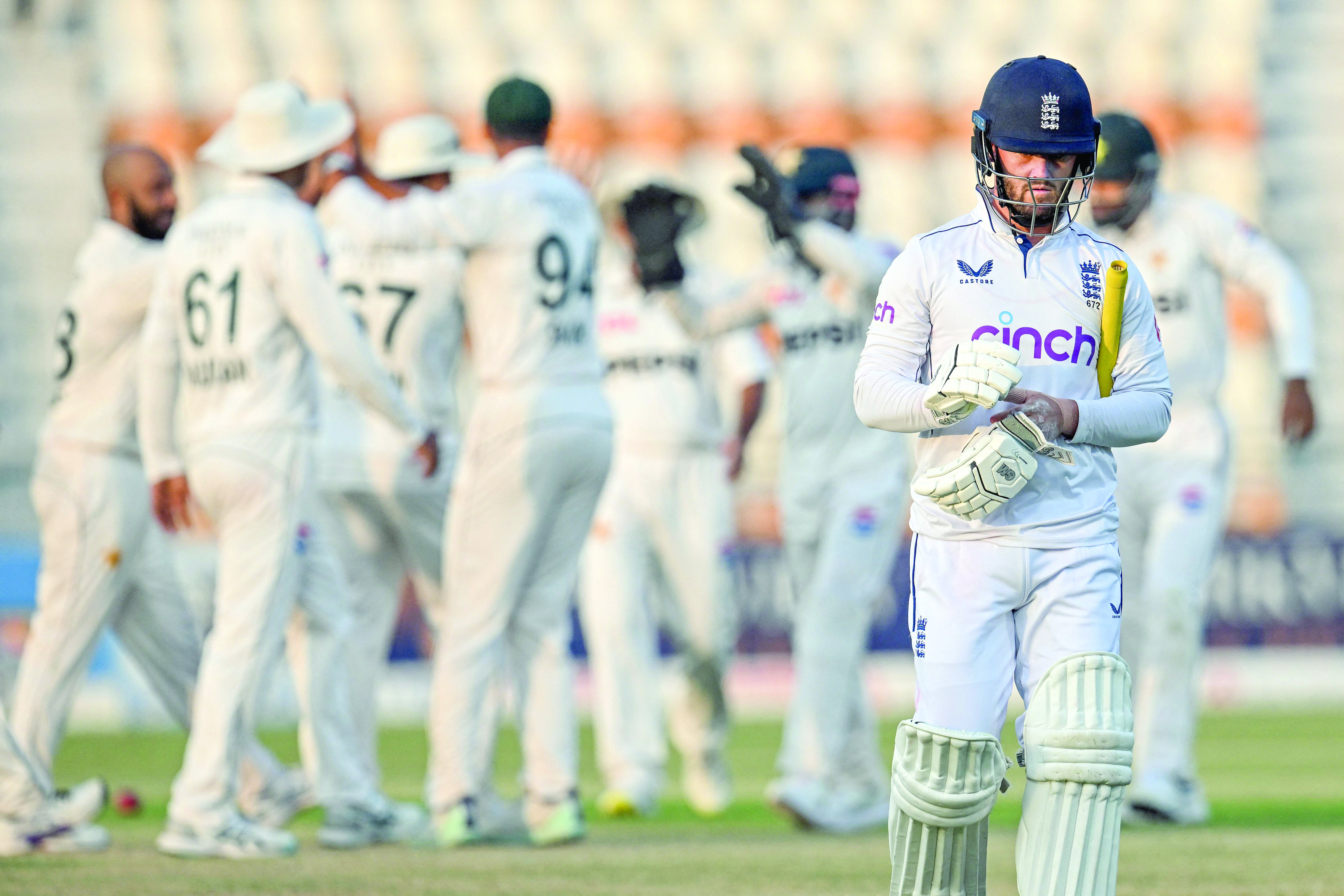 england s ben duckett walks back to the pavilion after his dismissal by pak spinner sajid khan on the third day of the second test in multan photo afp