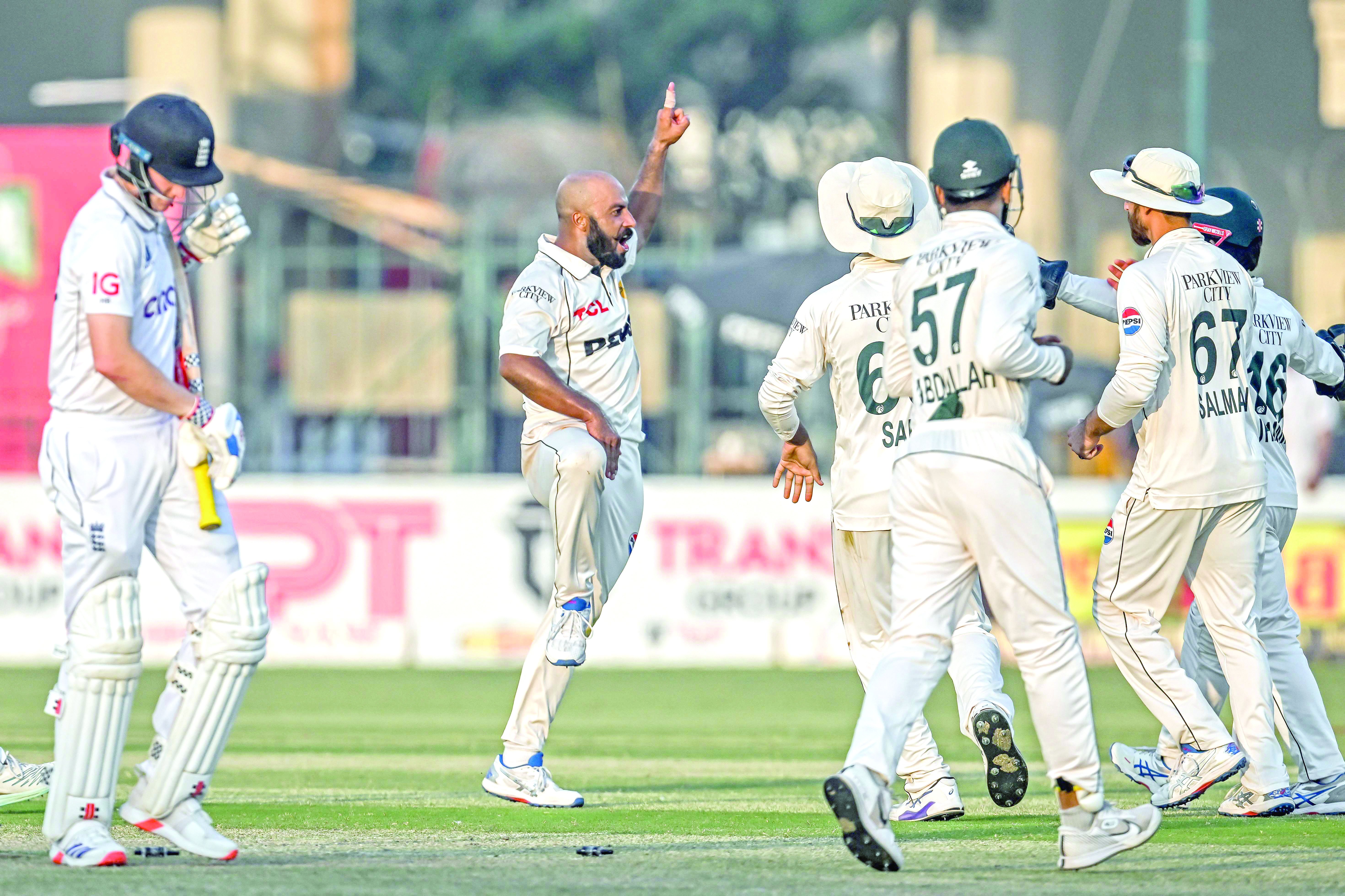 pakistan s sajid khan 2l celebrates with teammates after taking the wicket of england s harry brook l on the second day of the second test at multan photo afp